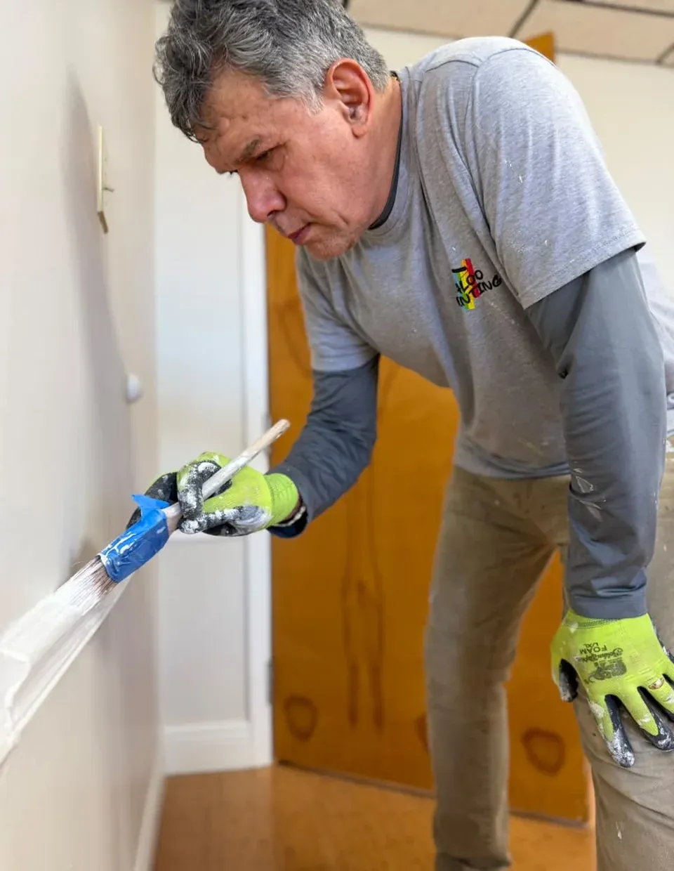 A Maloo Painting crew member sealing a door frame before painting